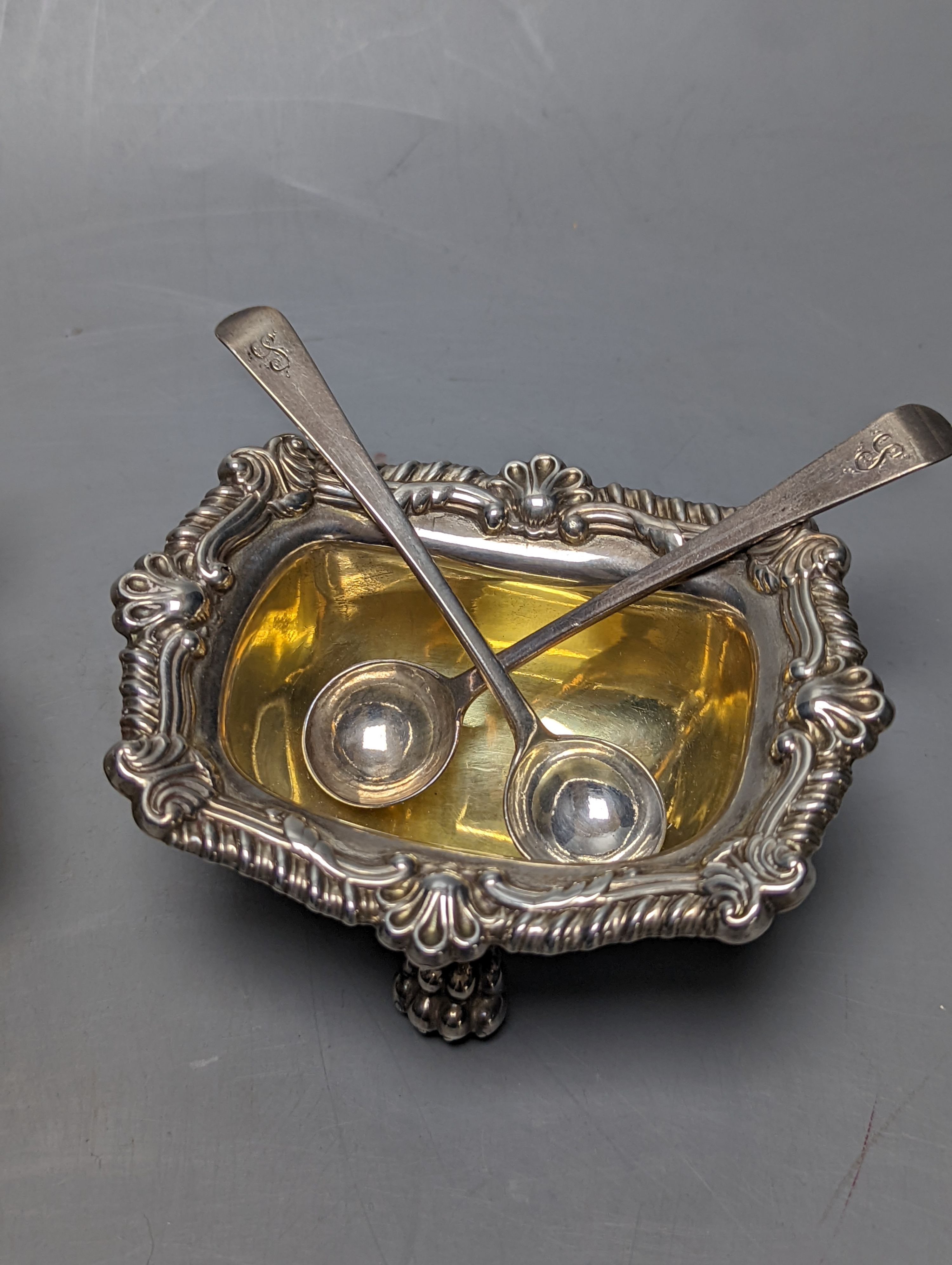 A pair of George III silver salts, with lion's paw feet, S.C.Younge & Co, Sheffield, 1817, 10.6cm, together with two pairs of associated George III silver condiment spoons